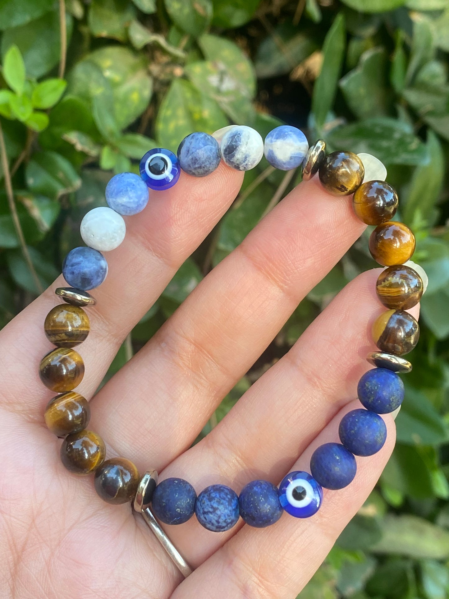 Sodalite, pyrite, tigers eye, lapis lazuli, and evil eye