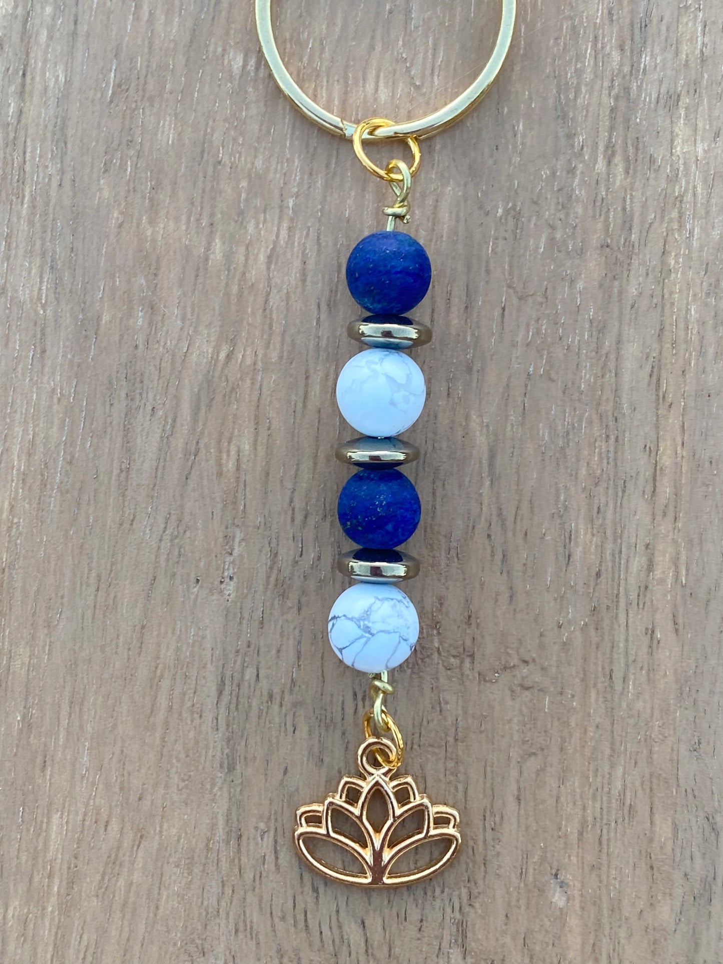 Gold keychain with lapis lazuli, pyrite, howlite, and lotus flower