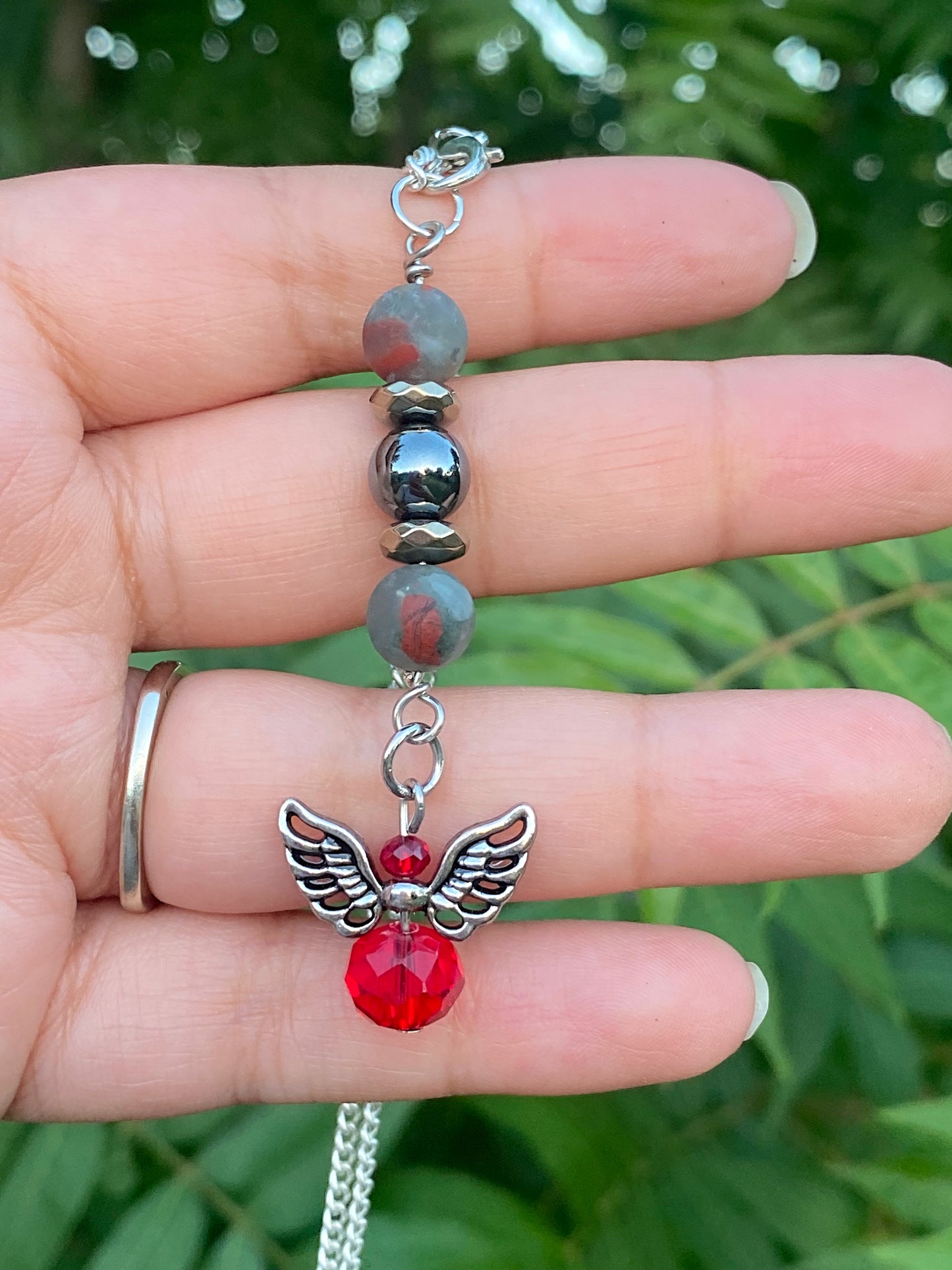 Crystal car charm with matte bloodstone, hematite, pyrite, and red angel